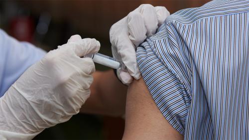 Close up of person receiving a shot.